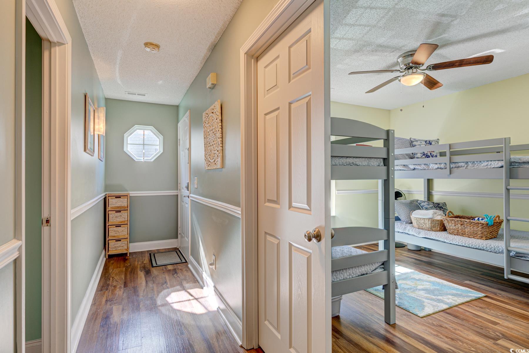 4840 Moss Creek Loop, Unit 36 Murrells Inlet, SC 29576 - Photo 9 of 37 Hall featuring dark wood-style floors and a textured ceiling