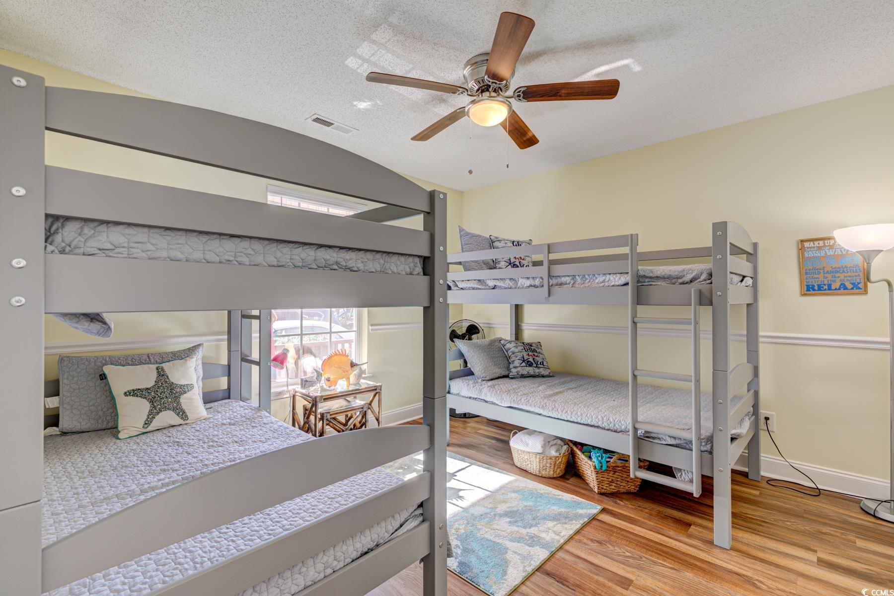4840 Moss Creek Loop, Unit 36 Murrells Inlet, SC 29576 - Photo 10 of 37 Bedroom with light wood-style flooring, a textured ceiling, and ceiling fan