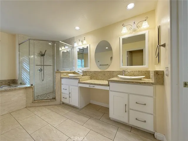 a spacious bathroom with a granite countertop sink mirror and a