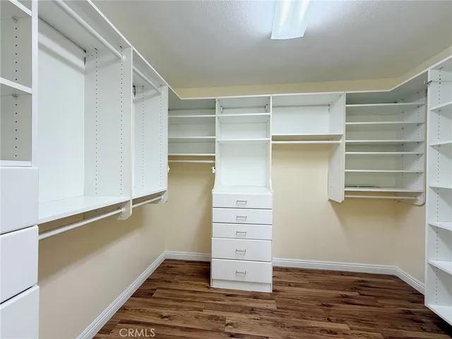 a view of walk in closet with empty racks