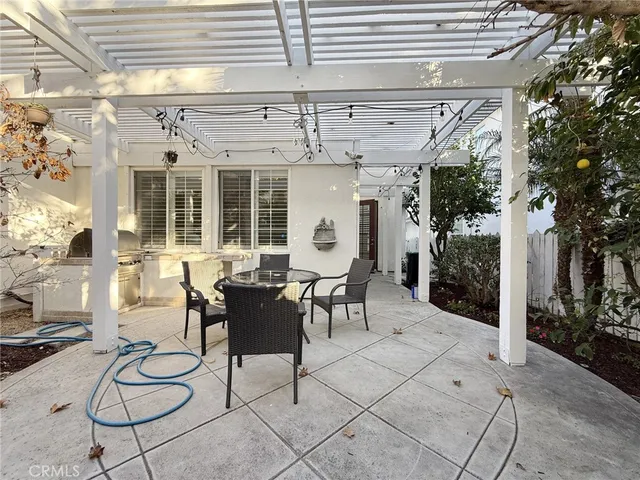 a view of patio with table and chairs and potted plants
