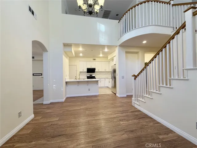 a view of a hallway with wooden floor and entryway