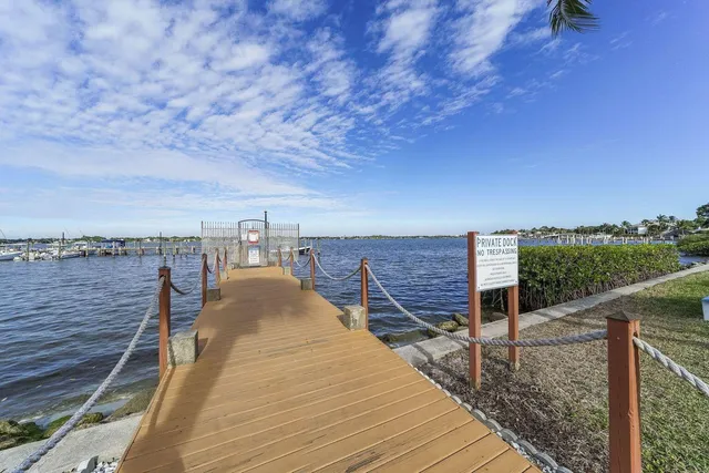 a view of roof deck with two chairs and a floor to ceiling window