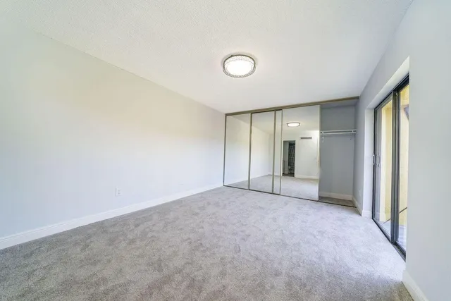 en empty room with windows and natural light