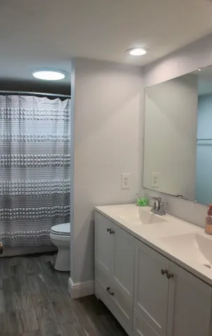 a spacious bathroom with a double vanity sink and mirror