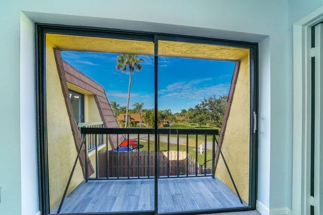 a view of a balcony with wooden floor and fence