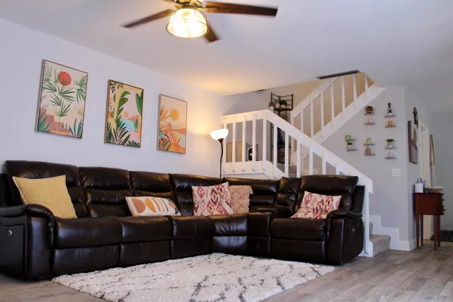 a living room with furniture and wooden floor