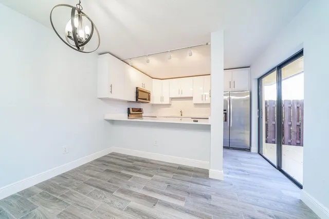 a view of kitchen and wooden floor