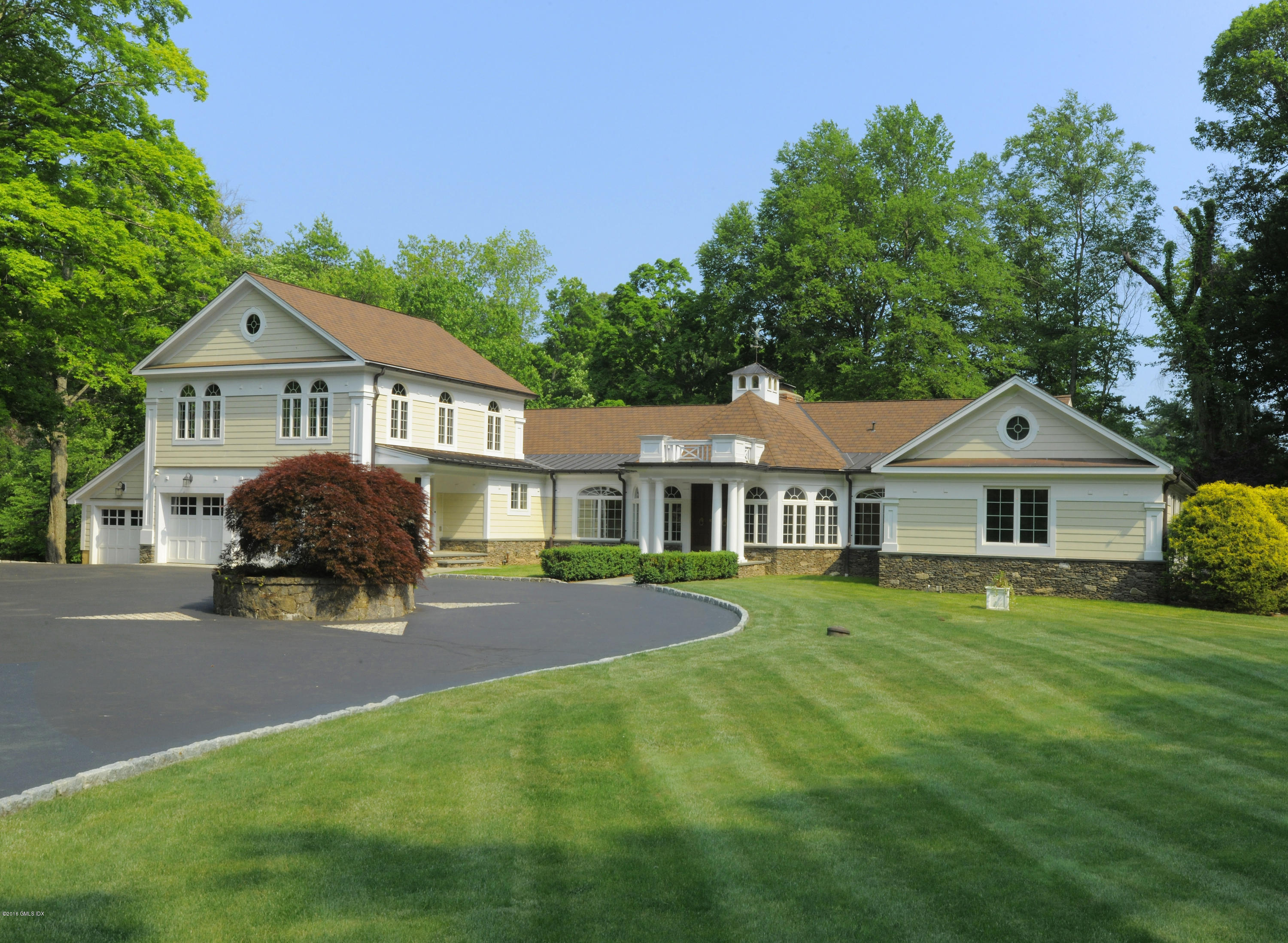 67 Burning Tree Road Greenwich, CT 06830 - Photo 1 of 28 a front view of a house with yard and green space