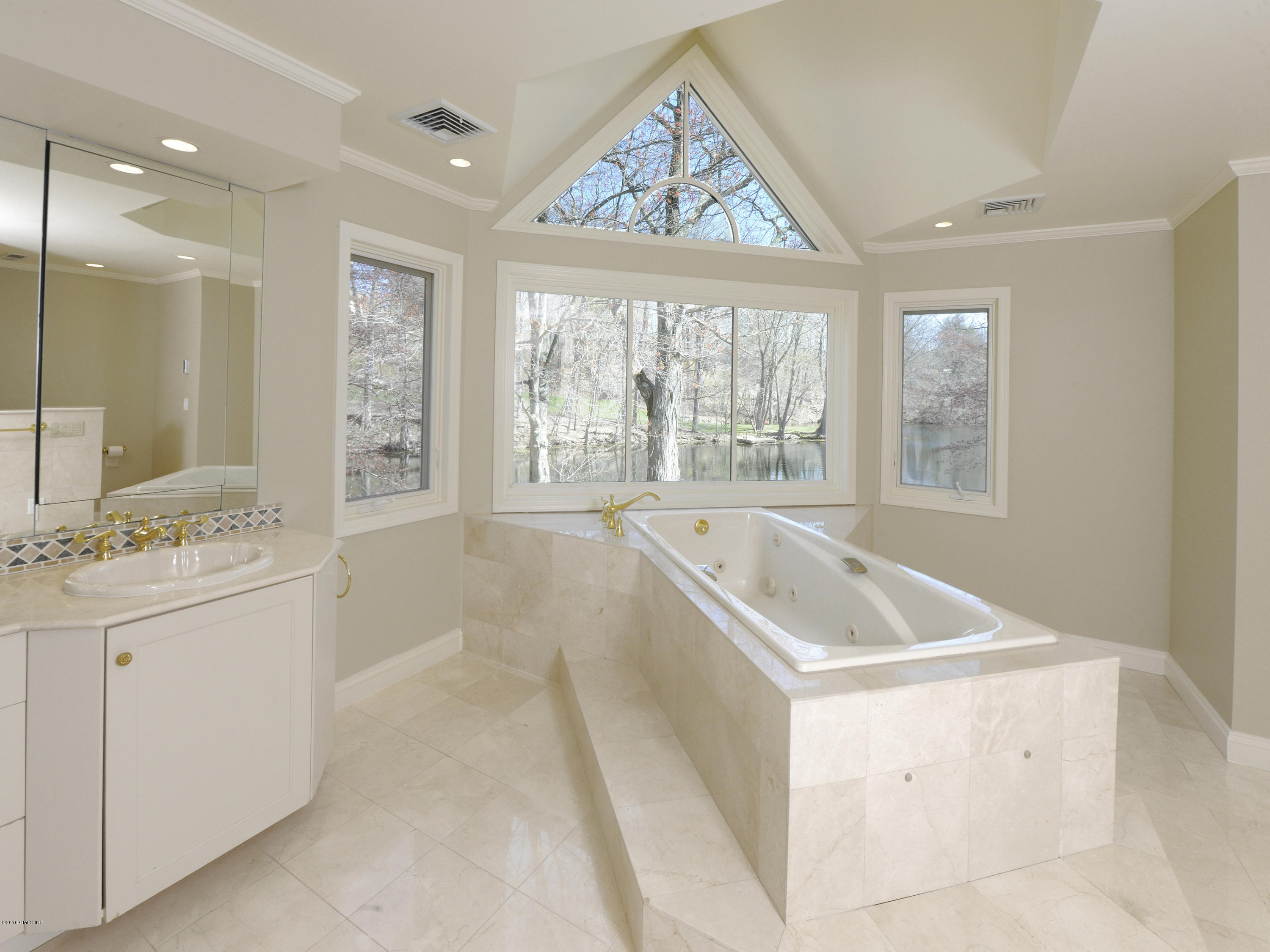 67 Burning Tree Road Greenwich, CT 06830 - Photo 13 of 28 a bathroom with a granite countertop sink mirror and a bathtub