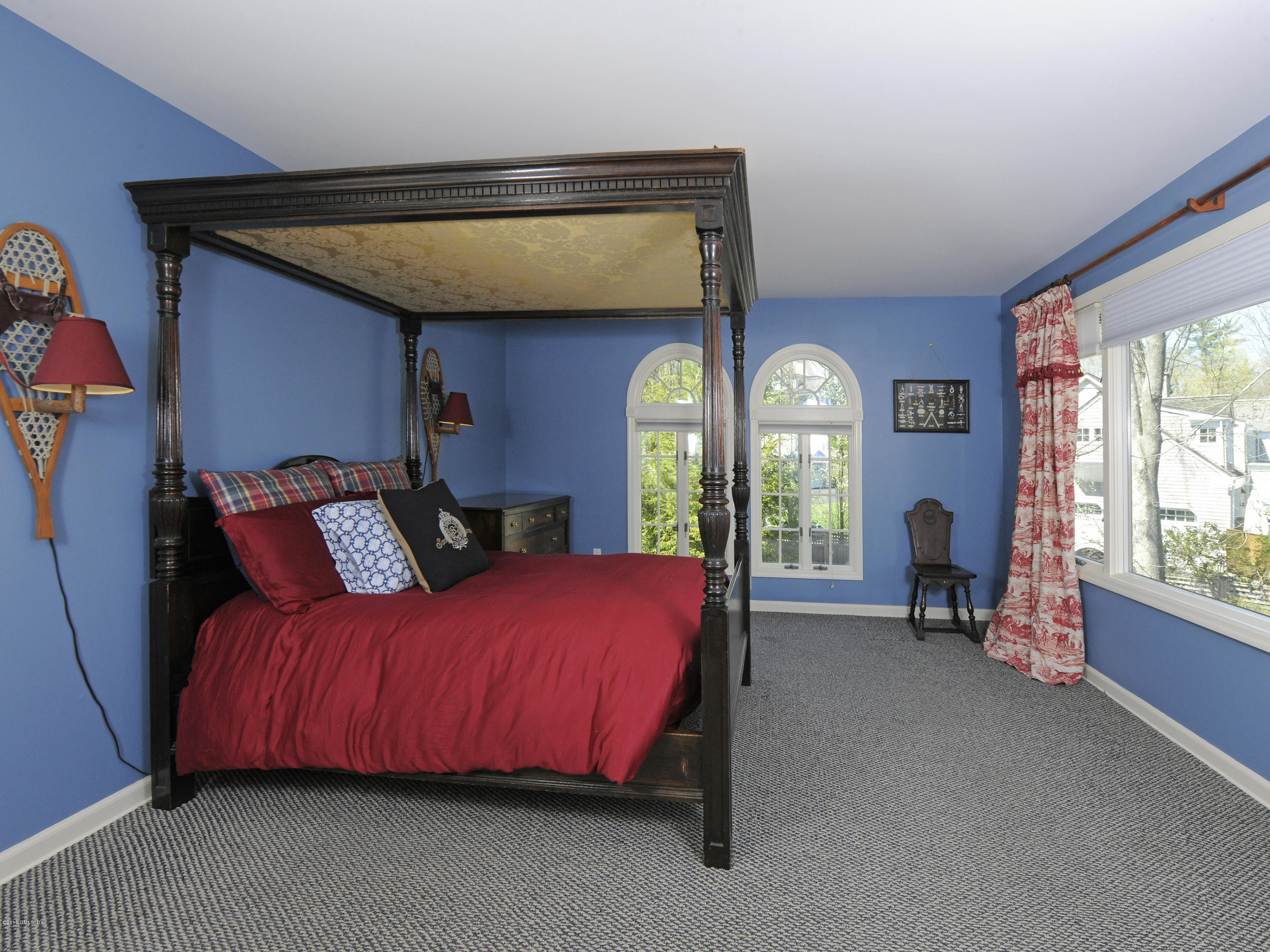 67 Burning Tree Road Greenwich, CT 06830 - Photo 14 of 28 a bed room with a bed and a chair