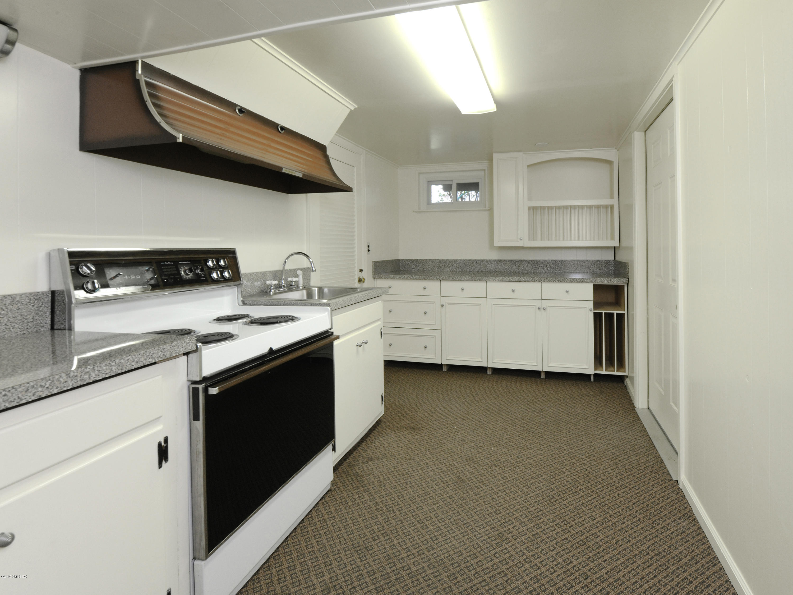 67 Burning Tree Road Greenwich, CT 06830 - Photo 20 of 28 a kitchen with a sink cabinets and stainless steel appliances