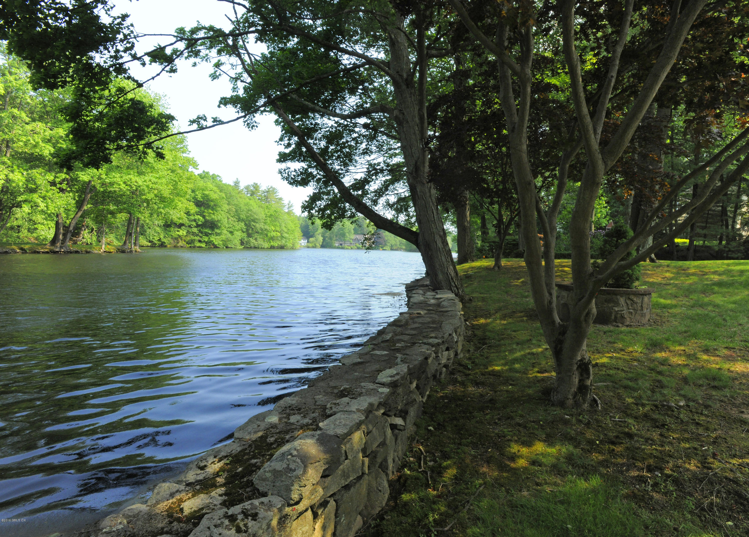 67 Burning Tree Road Greenwich, CT 06830 - Photo 26 of 28 a view of a lake from a yard