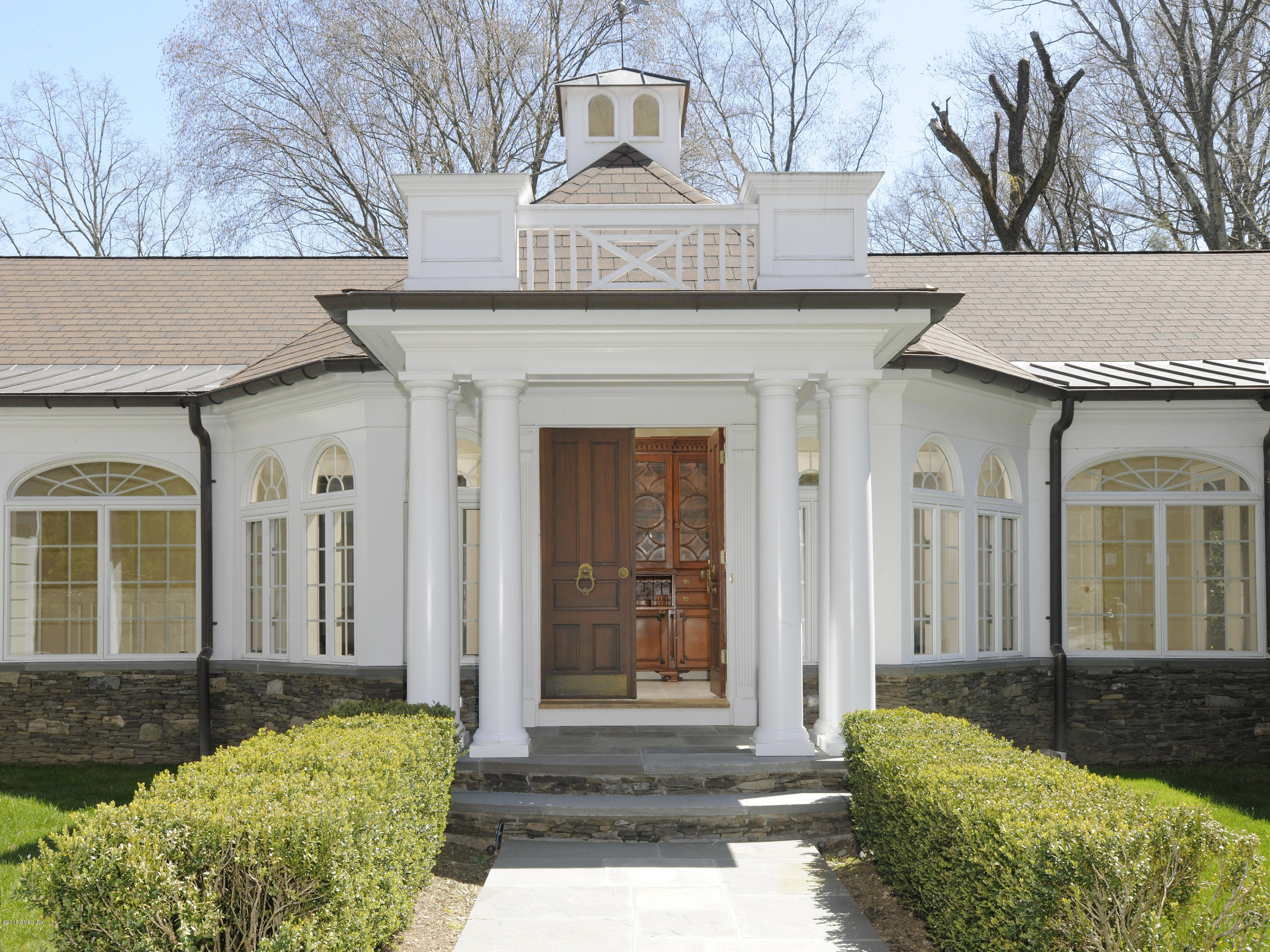 67 Burning Tree Road Greenwich, CT 06830 - Photo 3 of 28 a front view of a house with garden