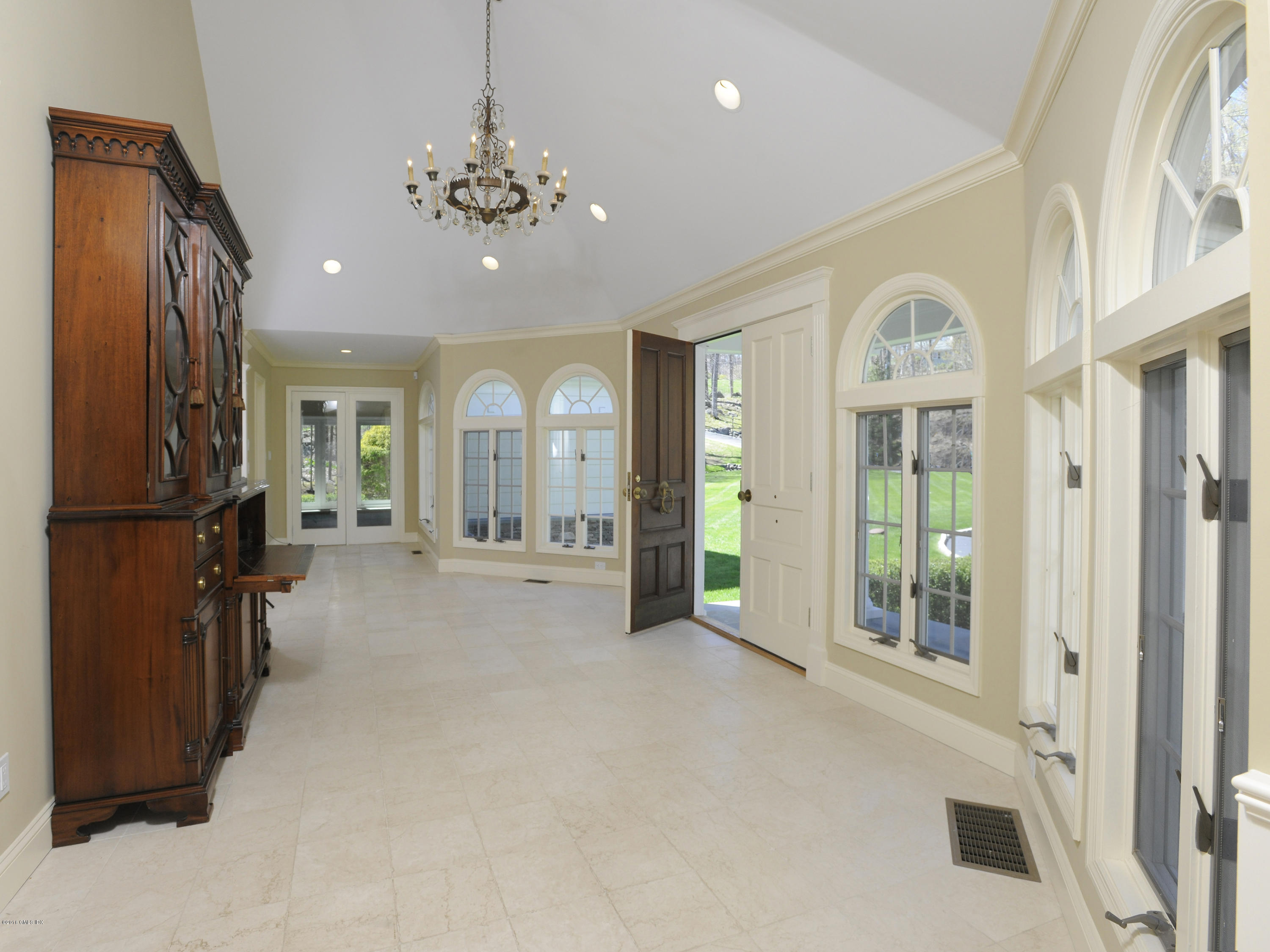 67 Burning Tree Road Greenwich, CT 06830 - Photo 5 of 28 a view of a room with lots of windows and chandelier