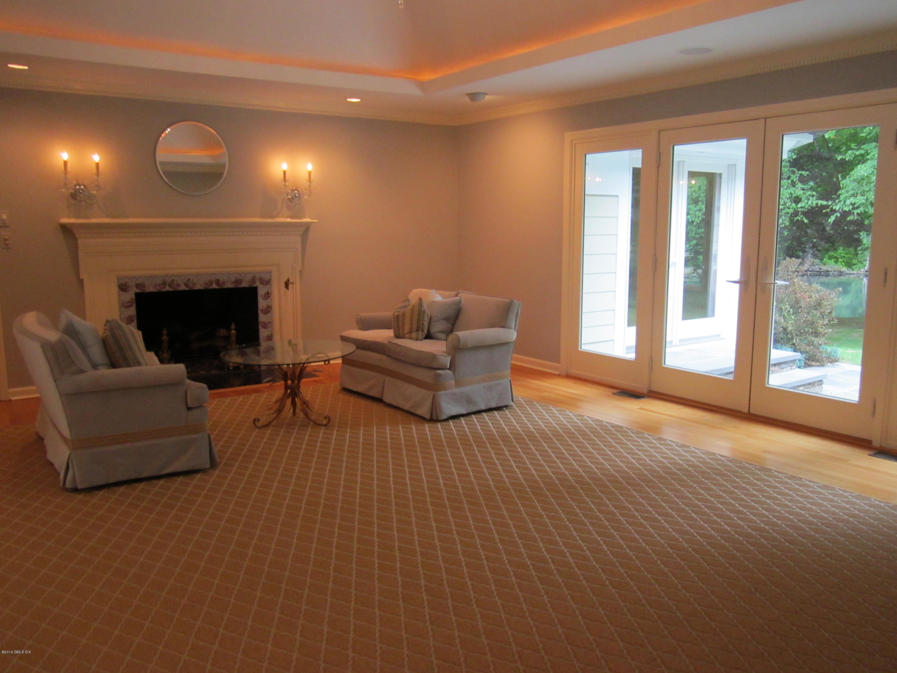 67 Burning Tree Road Greenwich, CT 06830 - Photo 7 of 28 a living room with furniture and a fireplace
