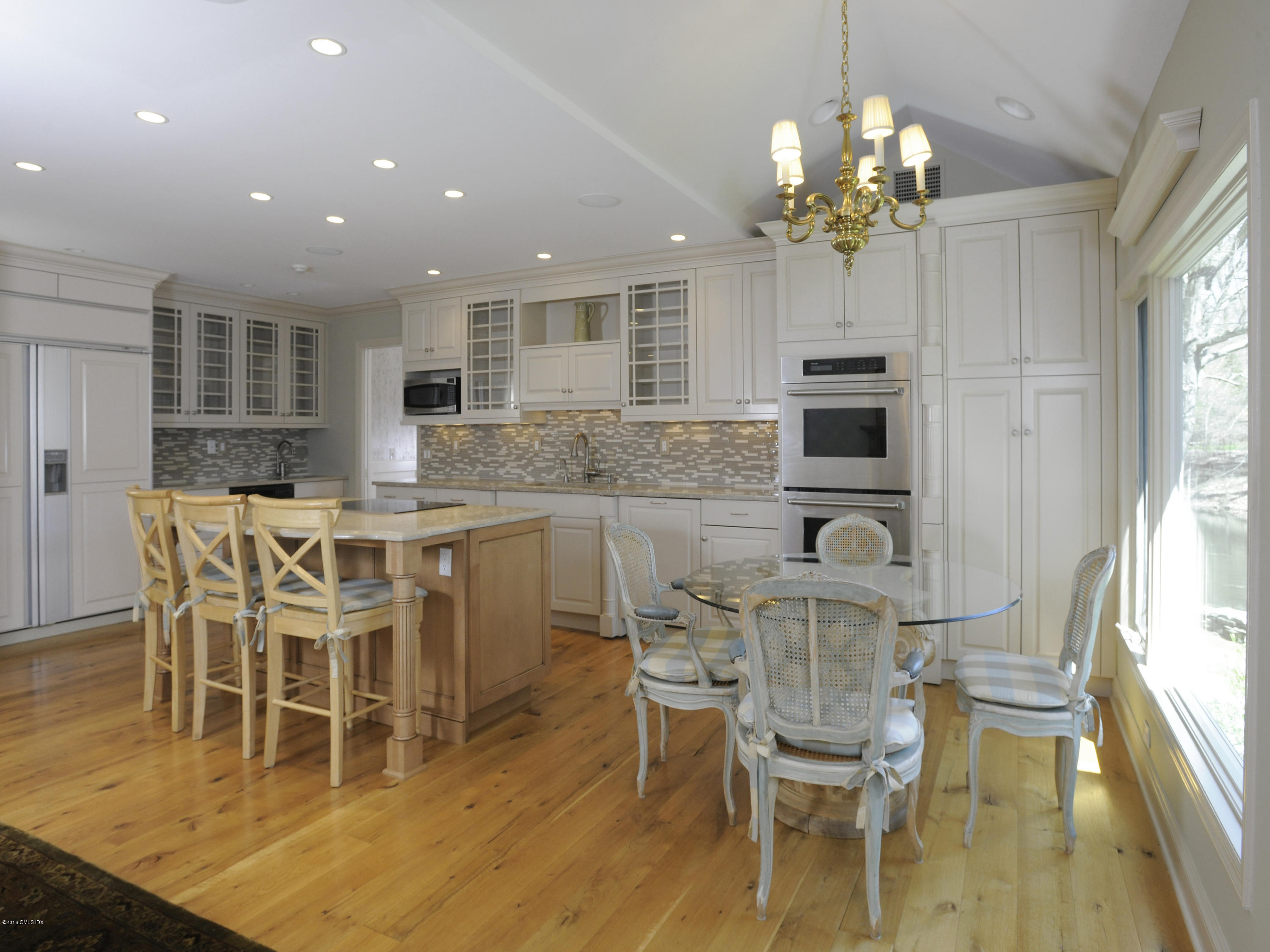 67 Burning Tree Road Greenwich, CT 06830 - Photo 8 of 28 a view of a dining room with furniture and wooden floor