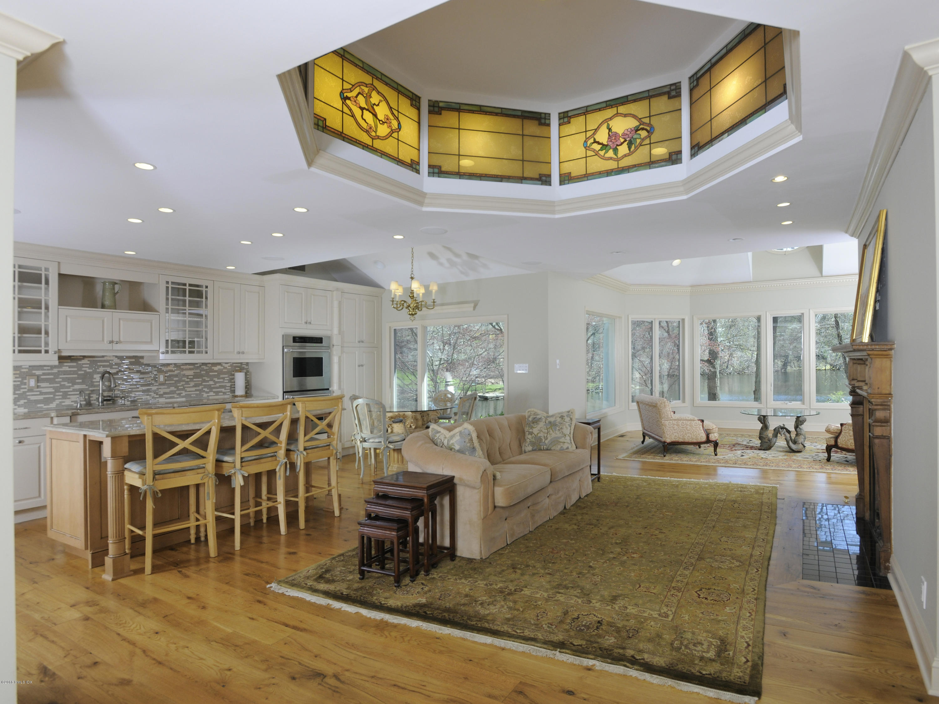 67 Burning Tree Road Greenwich, CT 06830 - Photo 10 of 28 a living room with lots of furniture and kitchen view