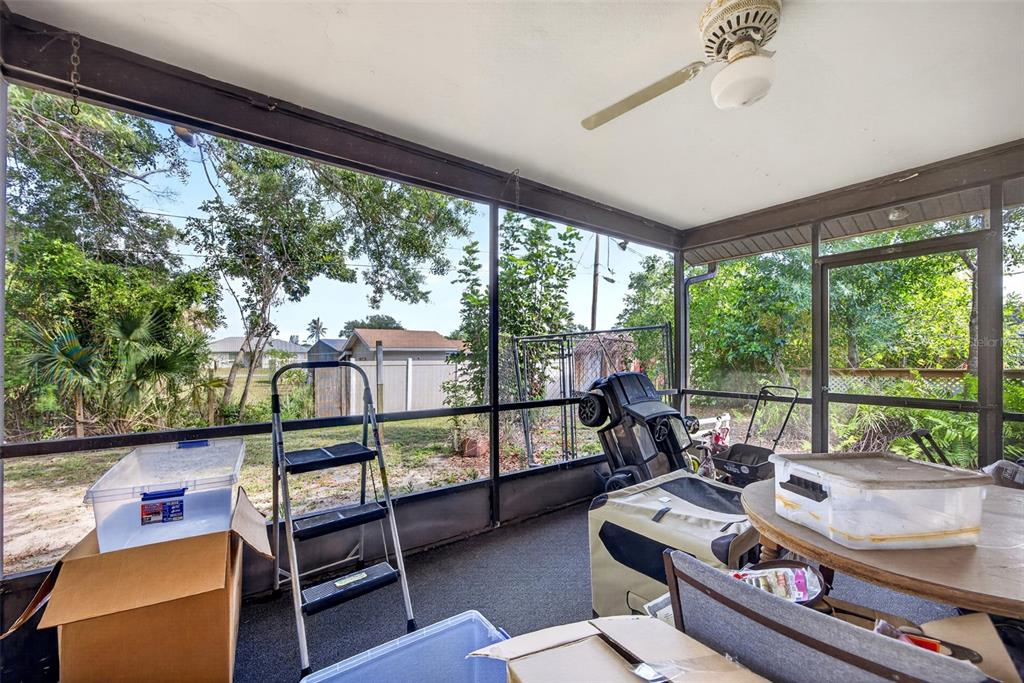 464 Coronado Road Venice, FL 34293 - Photo 17 of 28 a living room with furniture and a floor to ceiling window