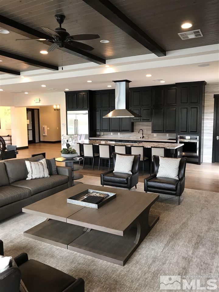9405 Hawkshead Road Reno, NV 89521 - Photo 33 of 40 a living room with furniture a table and kitchen view