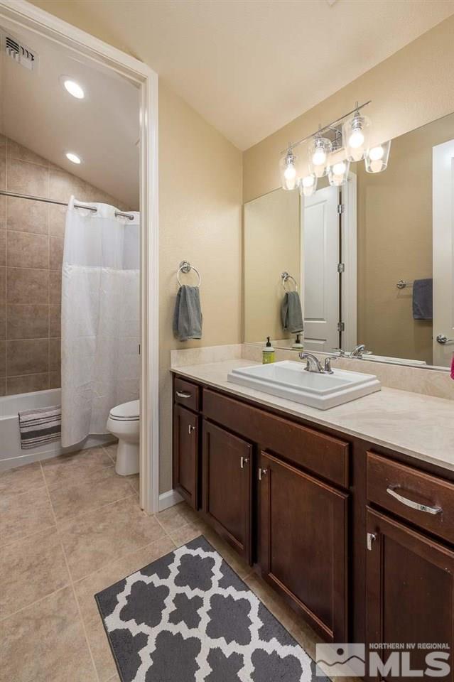 9405 Hawkshead Road Reno, NV 89521 - Photo 6 of 40 a bathroom with a double vanity sink toilet and a shower