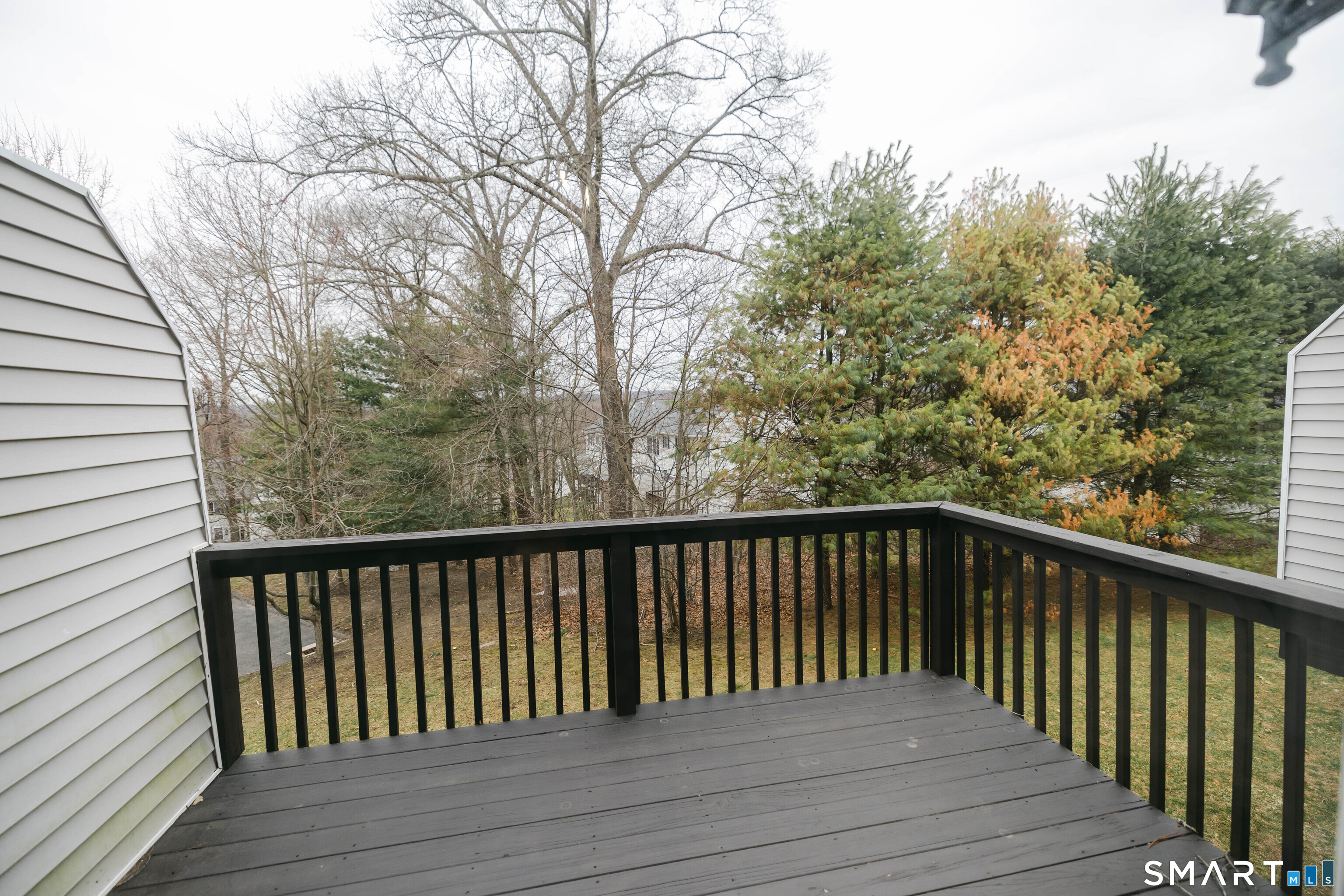 1502 Pinnacle Way, Unit 1502 Danbury, CT 06811 - Photo 14 of 45 a balcony with wooden floor and fence