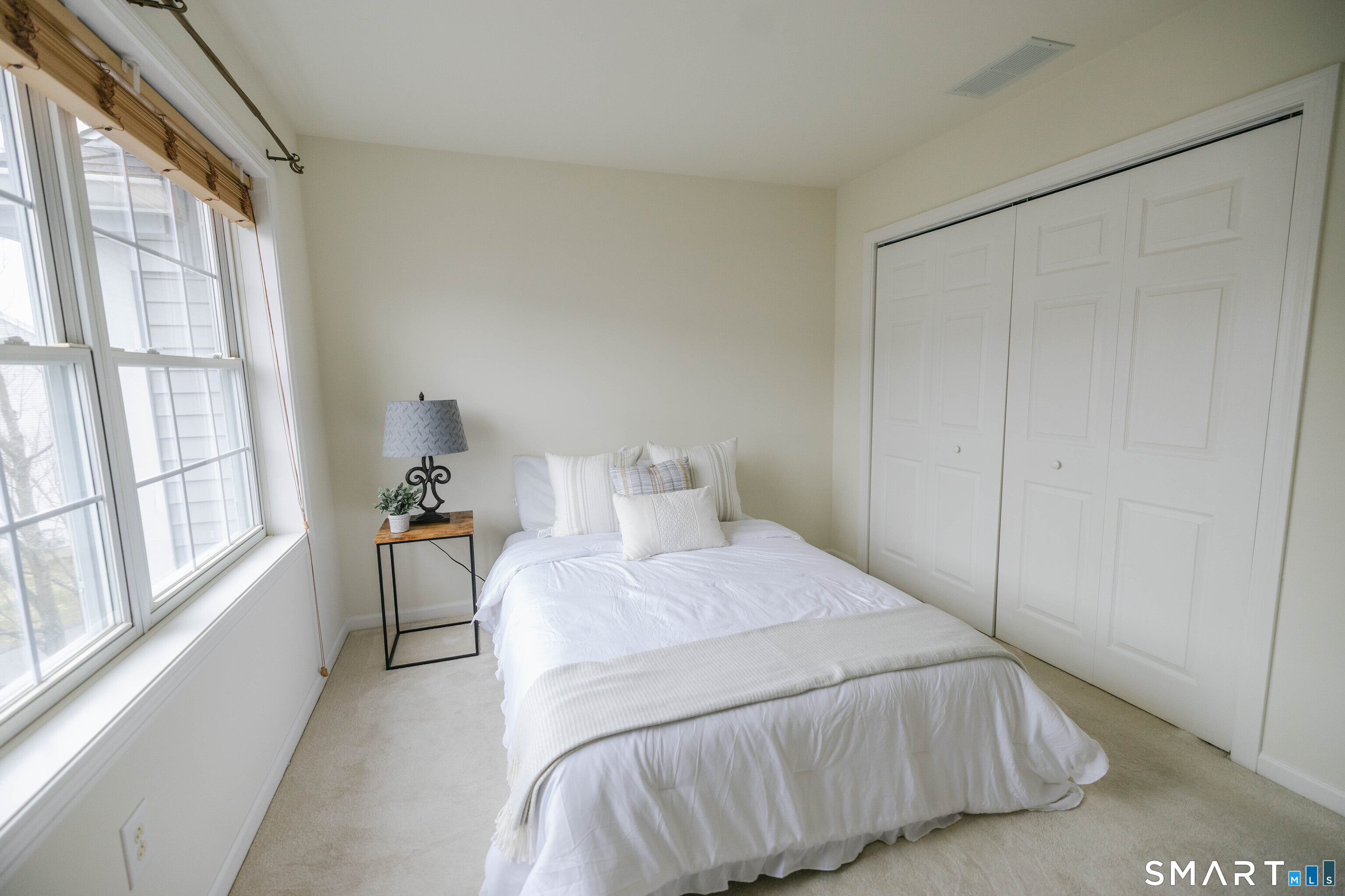 1502 Pinnacle Way, Unit 1502 Danbury, CT 06811 - Photo 24 of 45 a bedroom with a bed and a large window