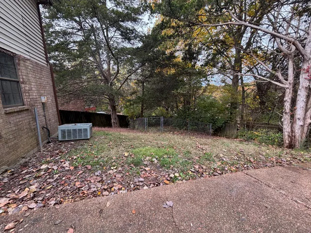 a view of a backyard with large trees