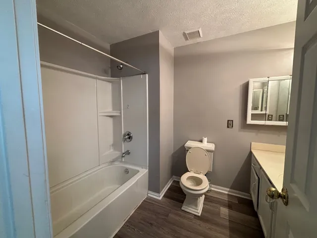 a bathroom with a toilet a sink and bathtub