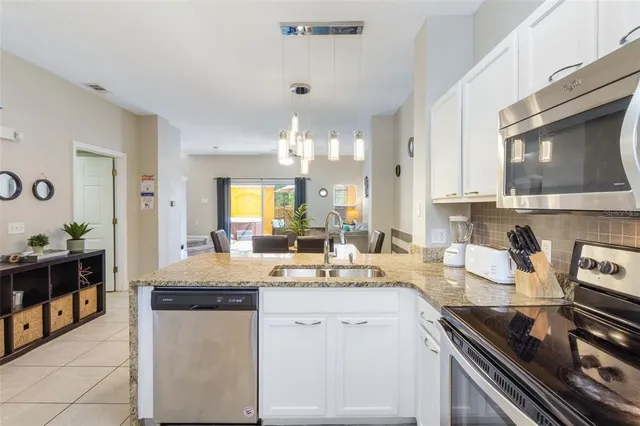 a kitchen with a sink stove and cabinets