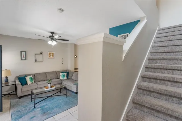 a living room with furniture and stairs