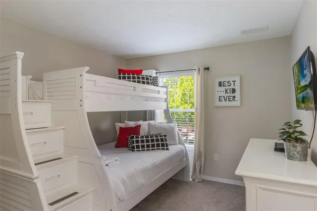 a bedroom with a bed and a potted plant