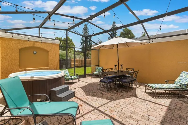 a view of a patio with table and chairs