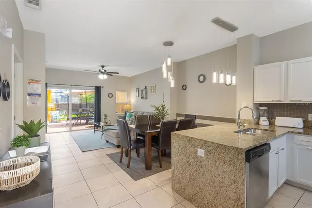 a large kitchen with kitchen island a table and chairs
