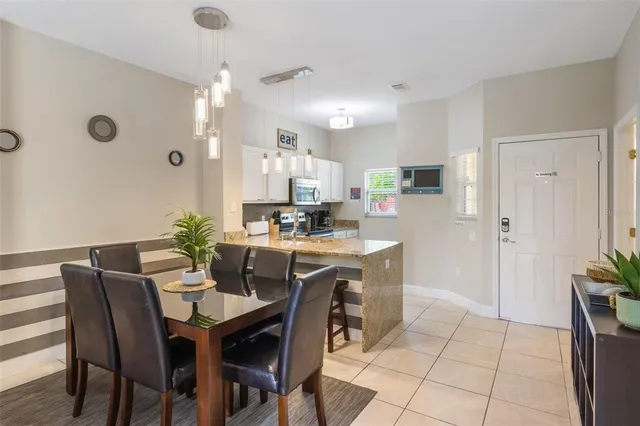a view of kitchen with refrigerator dining table and chairs