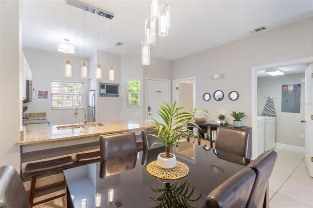 a dining room with furniture and a potted plant