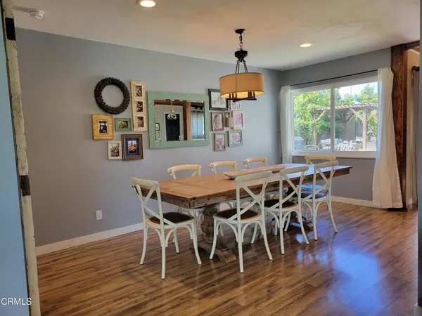a dining room with furniture and wooden floor