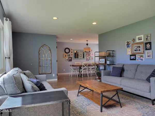 a living room with furniture a rug and a bookshelf