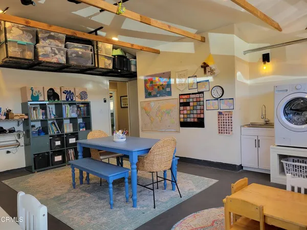 a kitchen with stainless steel appliances kitchen island granite countertop a refrigerator a stove and a sink with granite countertops