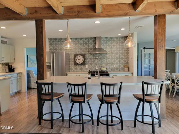 a stove top oven sitting inside of a kitchen
