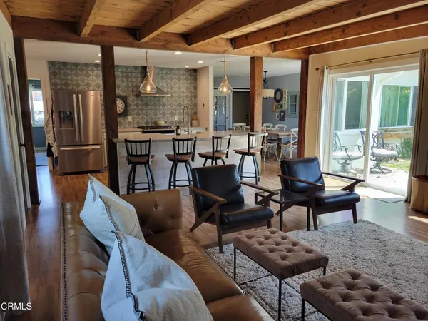 a view of a livingroom with furniture window and wooden floor