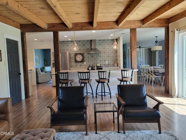 a large kitchen with stainless steel appliances kitchen island granite countertop a stove and a sink