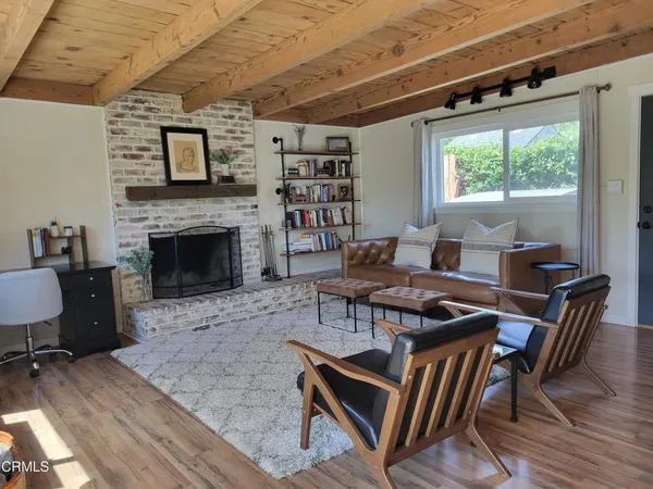 a open kitchen with stainless steel appliances granite countertop a stove and a dining table with wooden floor
