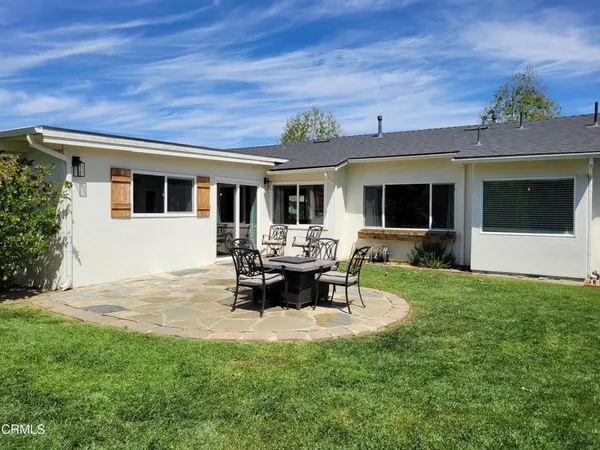 a view of a backyard with sitting area
