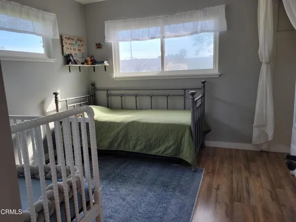 a bedroom with a bed and windows