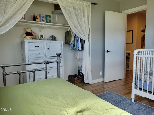 a bedroom with furniture and wooden floor
