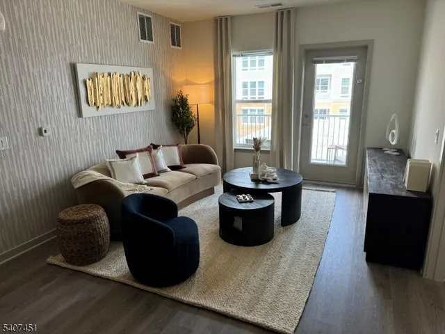 a living room with furniture potted plant and windows