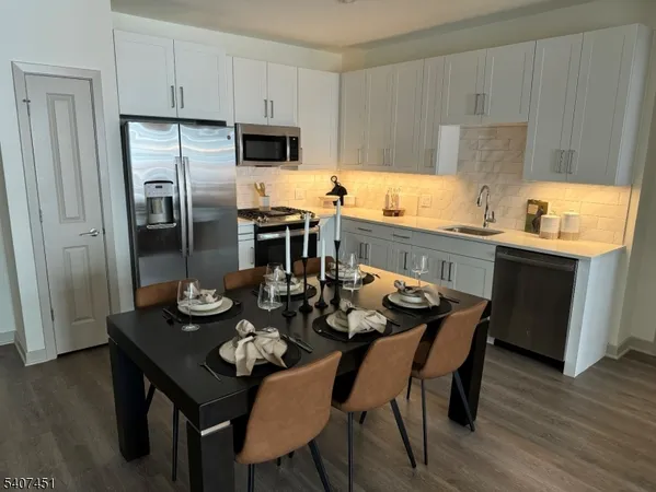 a kitchen with a dining table and chairs