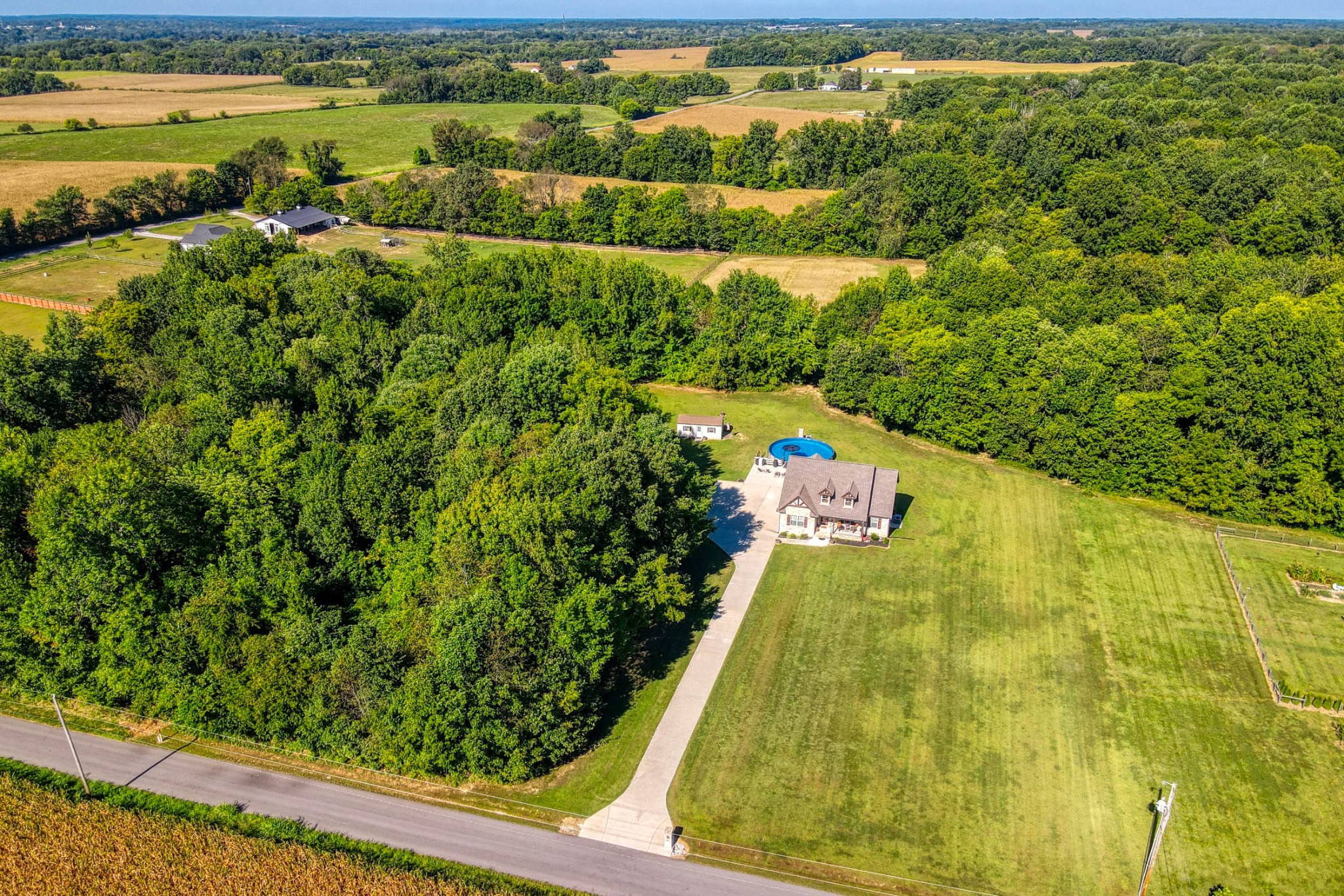 an aerial view of residential houses with outdoor space and swimming pool