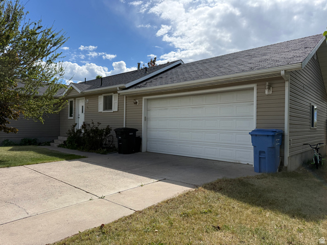 44 Wapiti Loop Hyrum, UT 84319 - Photo 17 of 18 Single-story residence featuring light-colored siding, a dark shingle roof, and a two-car garage